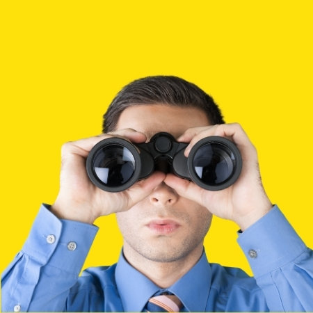 Man looking through binoculars